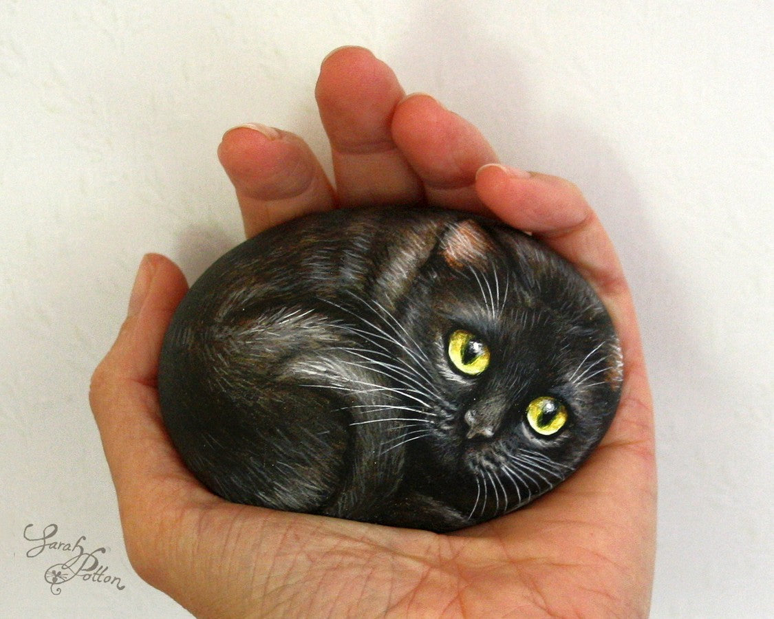 black cat with green eyes hand painted stone