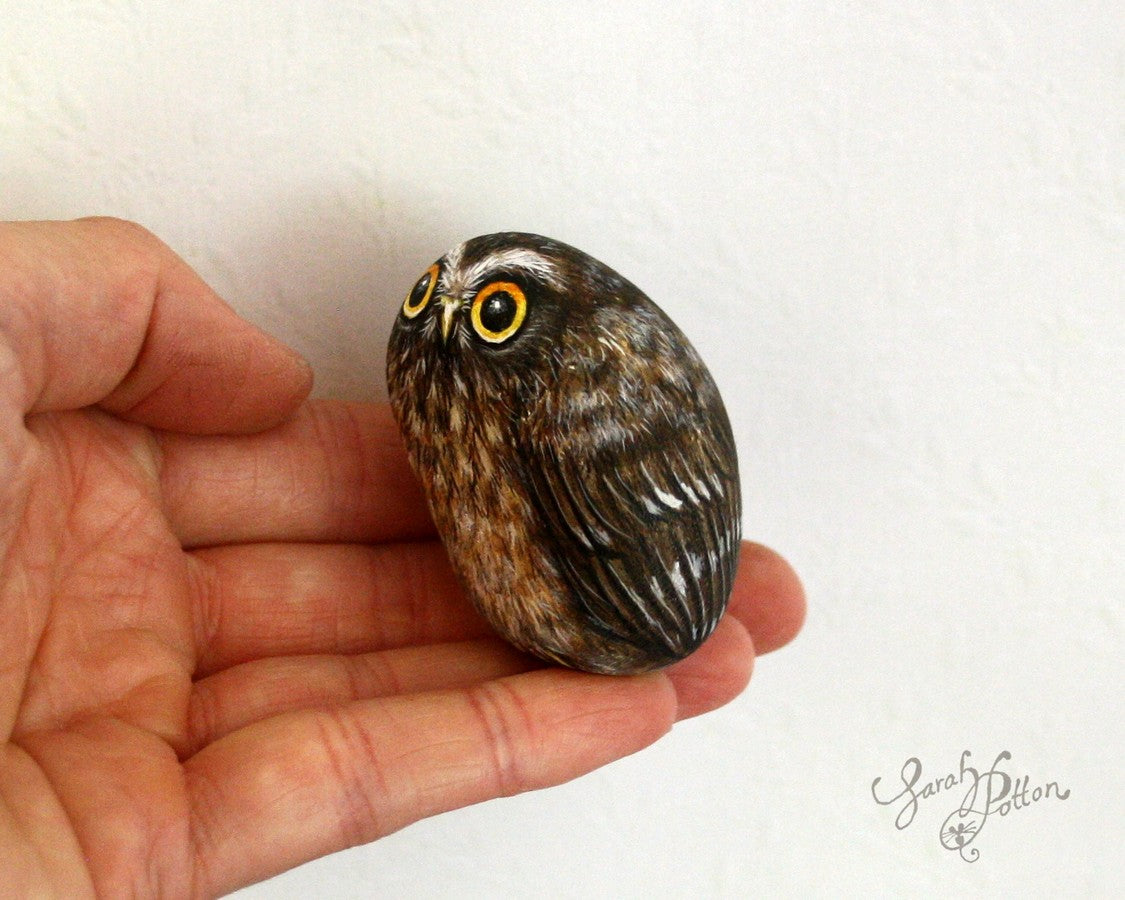 nz morepork hand painted on a stone