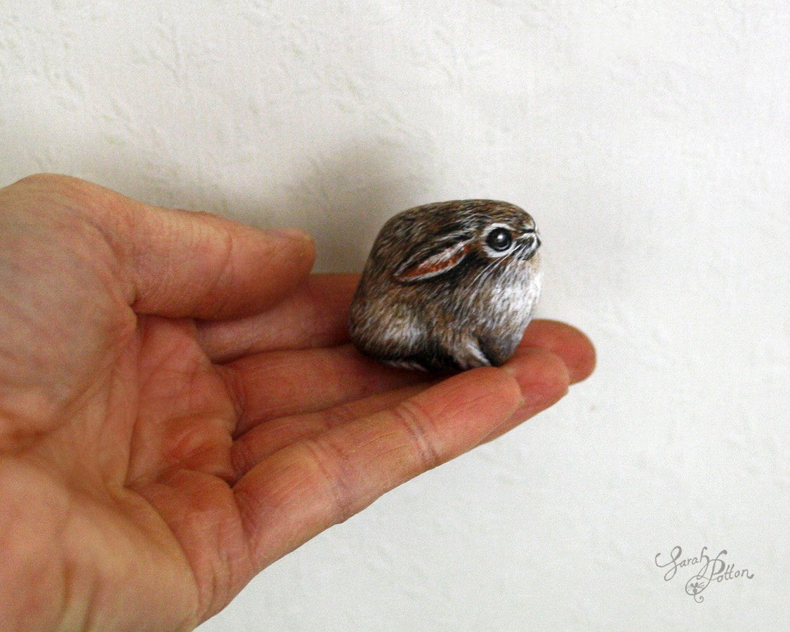 tiny painted rock of a wild rabbit 